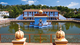 Image of a holy site with a waterbody in front of it.