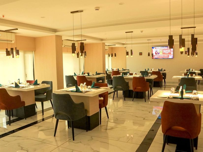 inside view of tangelo restaurant decorated with soothing ambience - Mastiff Hotel, Ankleshwar