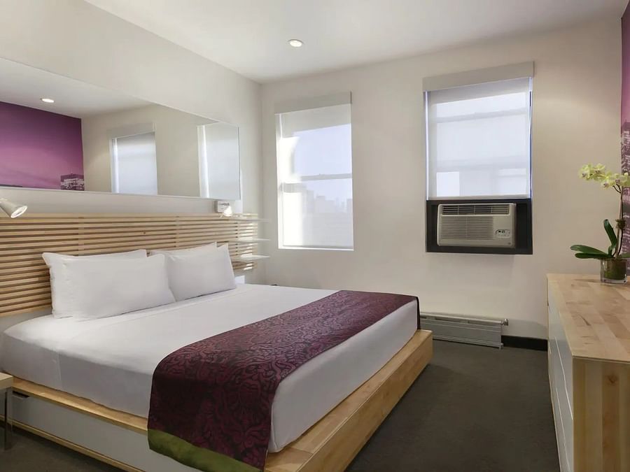 rooms with beds and large windows that overlook the surroundings