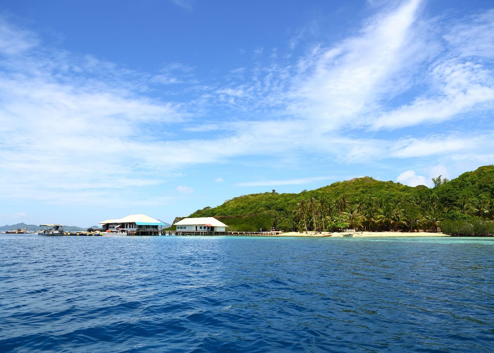 Ocean view with distant island and boats near Flower Island Resort.