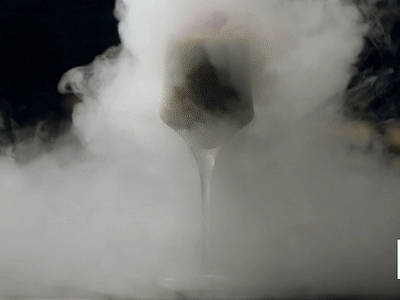 Dramatic smoke effect over a dish presented with a modern touch.