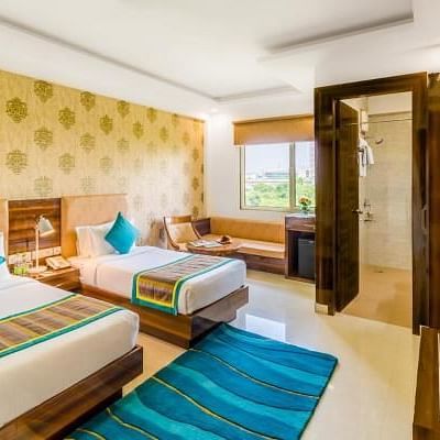 Image of Deluxe Twin Room featuring twin beds, sofa and a TV | Inde Hotel Cyber City
