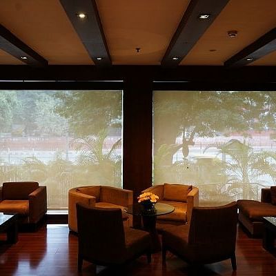 Guest Launge Area at Shervani Nehru Place, New Delhi with comfy sofa with a beautiful view.