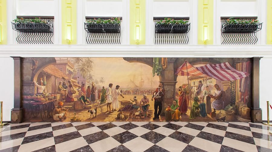Lobby area with checkerboard-tiled floor and walls adorned with vintage paintings