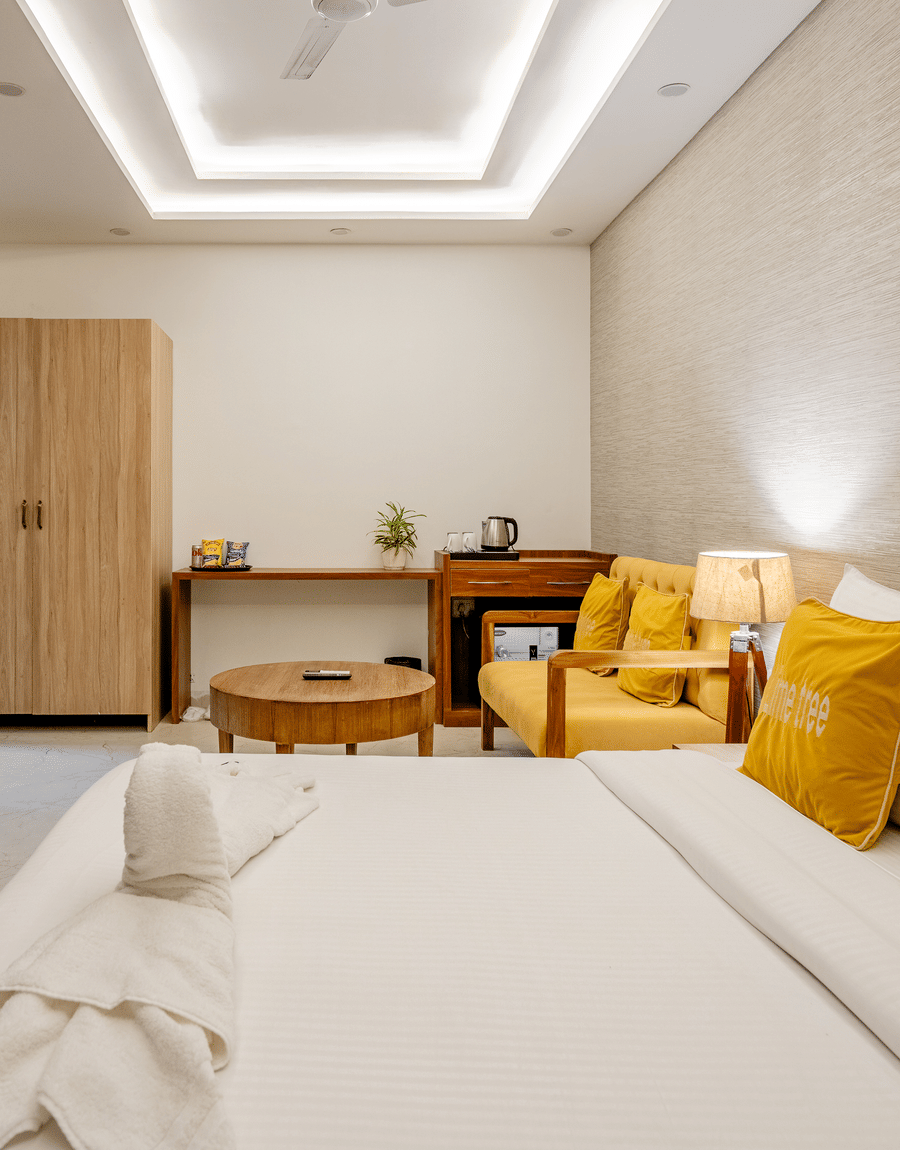 An overhead perspective of a premium hotel bedroom suite showcasing pristine white bed linen.