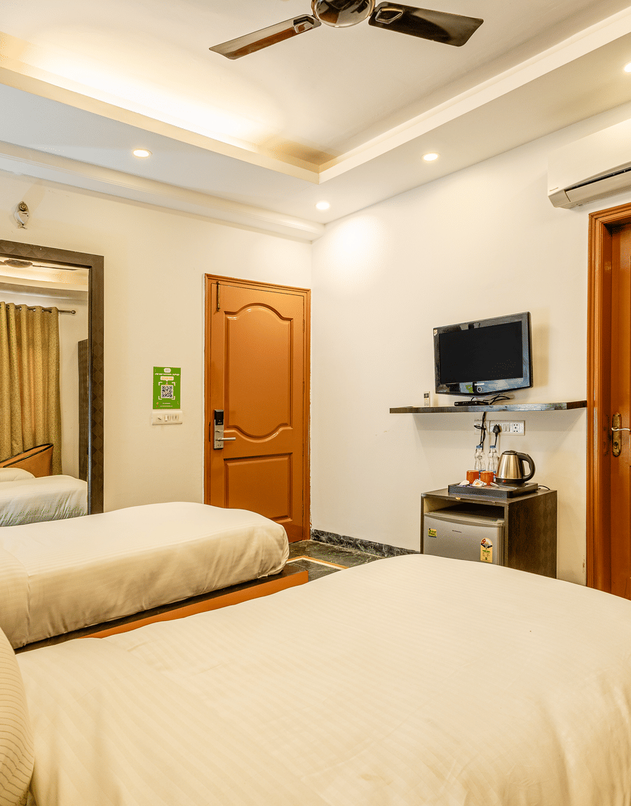 Twin beds facing television in the superior double or twin room at Lime Tree Hotels and Banquet Hall Near Huda Metro, Gurgaon