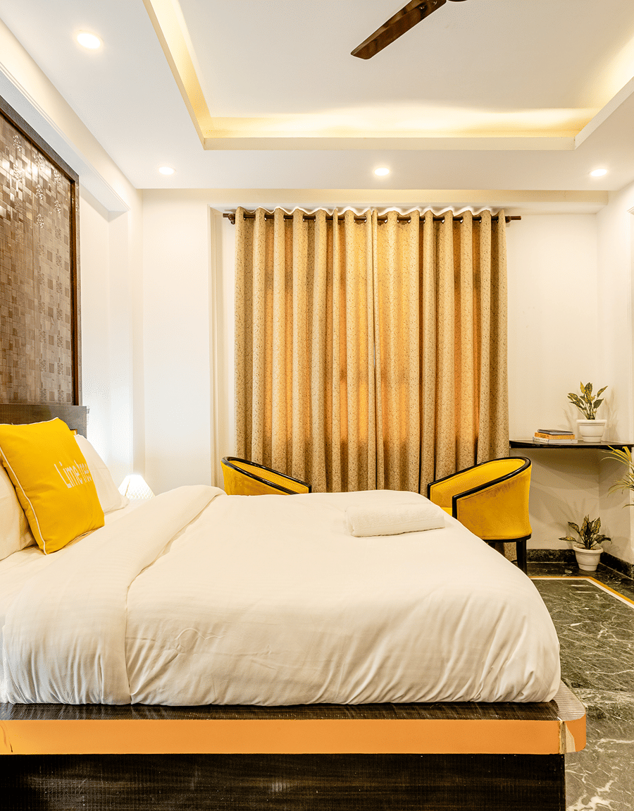 Superior King Room with a king bed and wall-mounted TV at Lime Tree Hotel and Banquet, Sushant Lok, Gurgaon