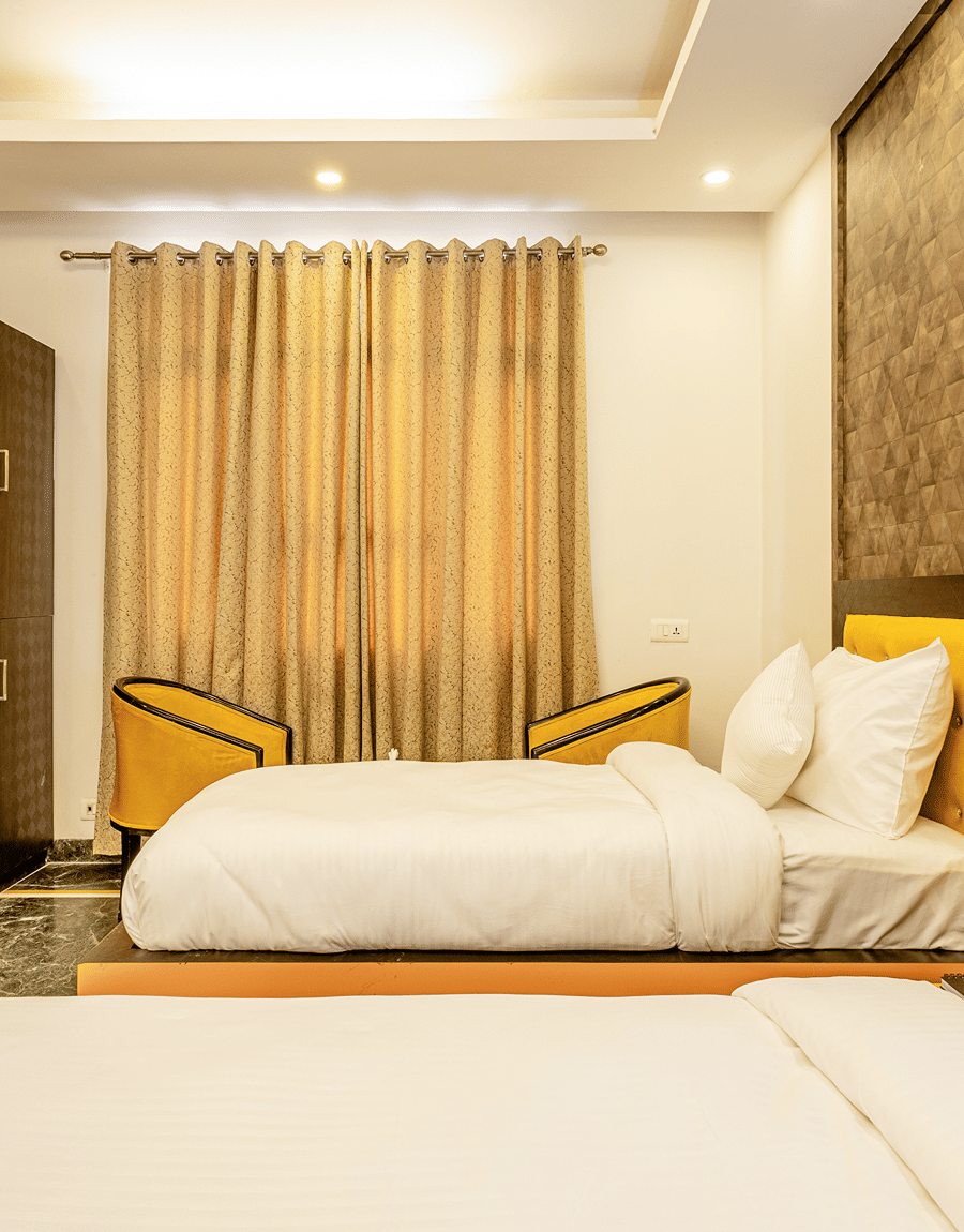 side view of twin beds in the superior double or twin room at Lime Tree Hotels and Banquet Hall Near Huda Metro, Gurgaon