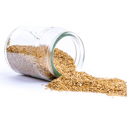 An image of glass jar is tilted on its side, spilling out a quantity of small seeds on a plane surface.