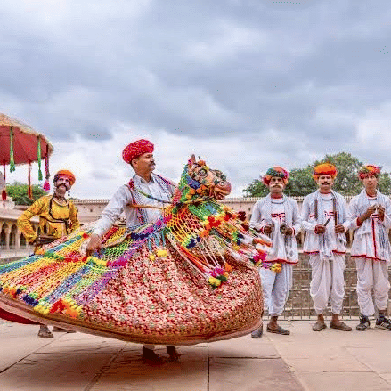 Traditional Rajasthani folk dancers performing at a wedding celebration at Umaid Palace.