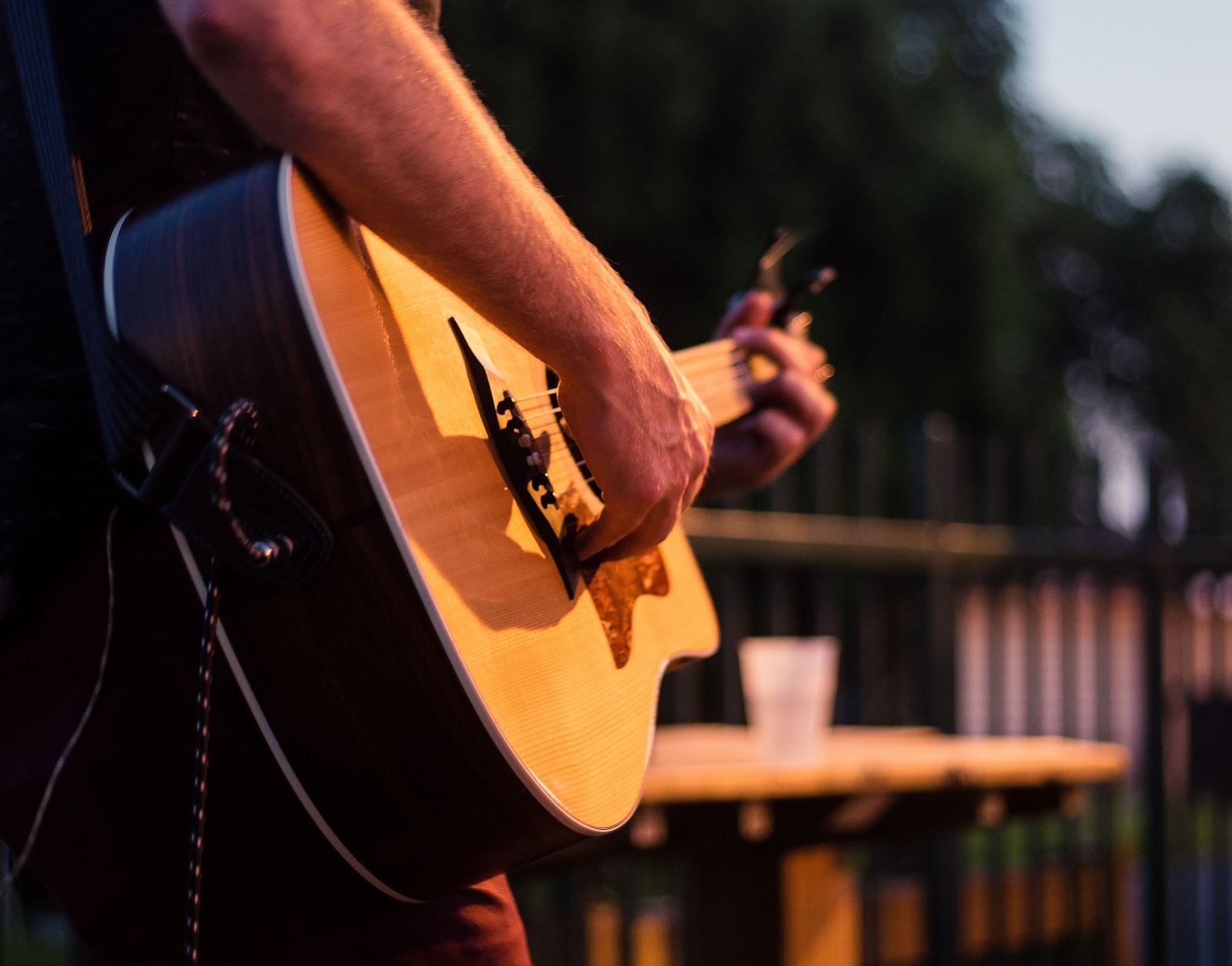 a person playing a guitar with the background blurred