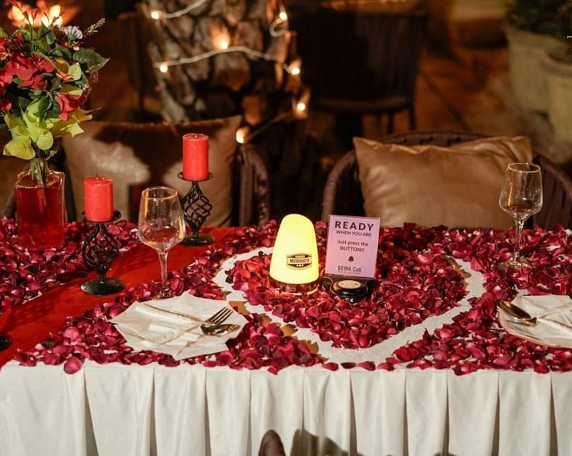 alt-text Candle light dinner with a rose petal decoration at themis mudhouse.