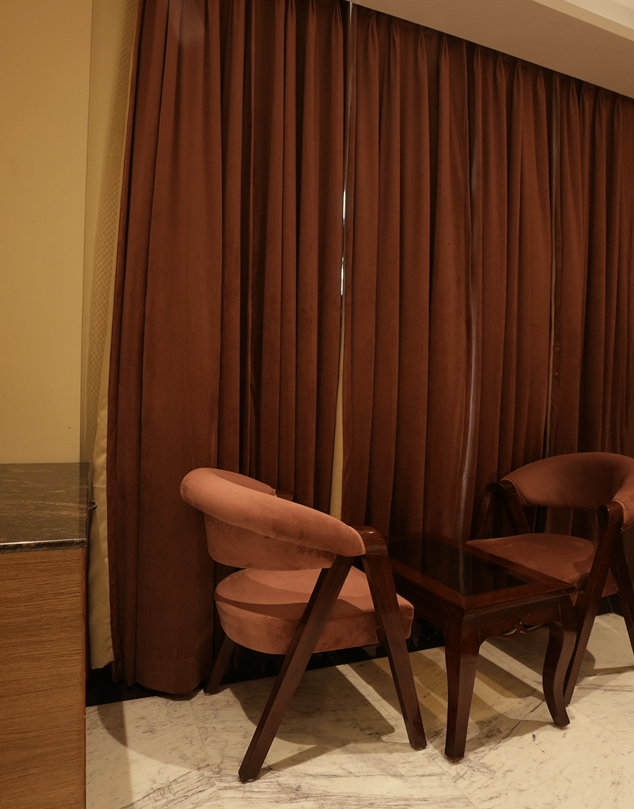 Cosy seating space with two chairs and a table at Lime Tree Hotel Near India Expo Mart, Greater Noida.