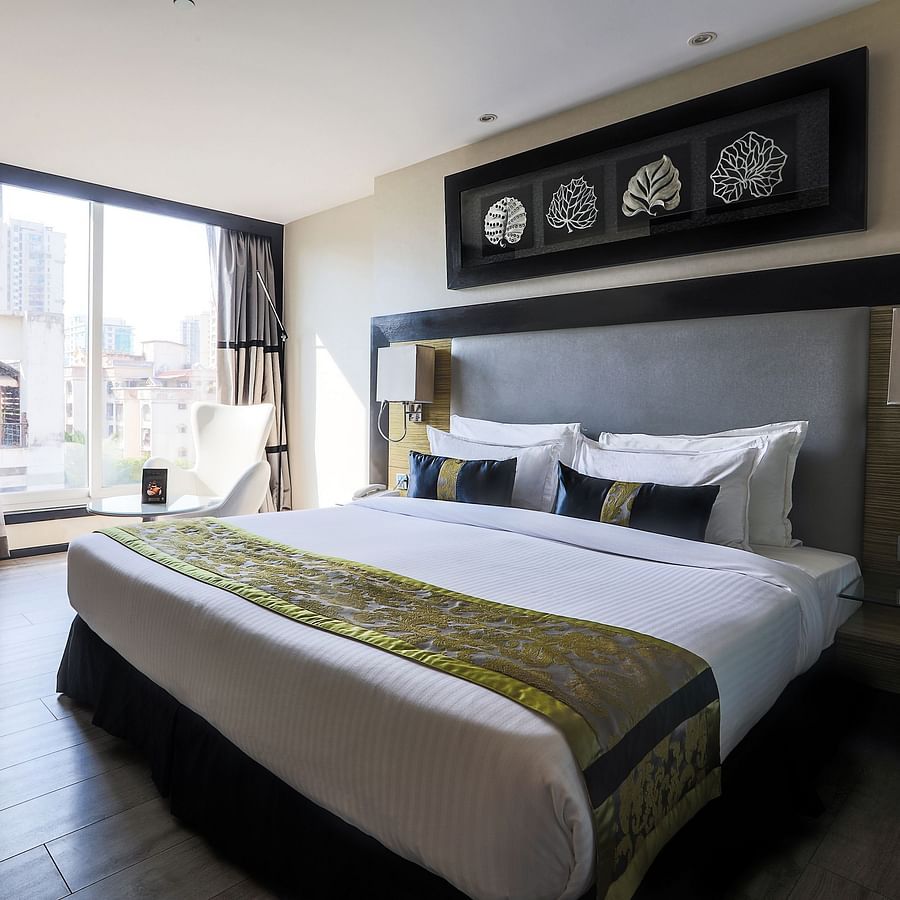 The Empresa Boutique Hotel - the king size and a sitting space beside it in the Executive Room in Andheri during daytime
