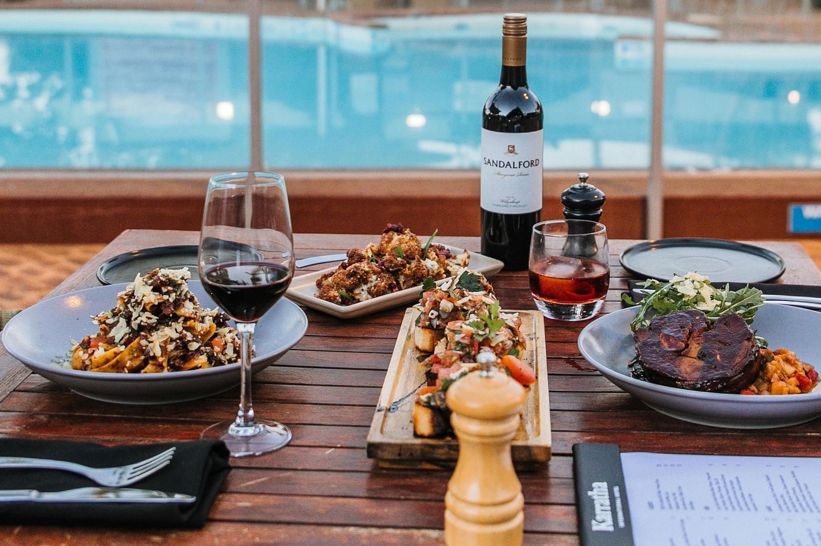 a table set beside a pool