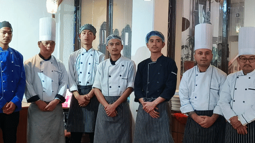 A group of professional chefs posing for a photo