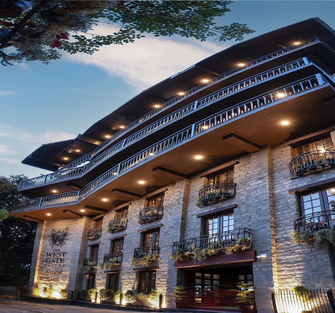 Shot of the facade of the hotel during the evening with a backdrop of blue sky.