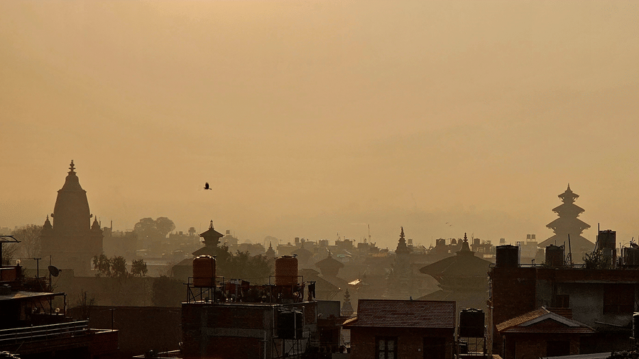 The rooftop offers a city view with the silhouette of buildings against the skyline.