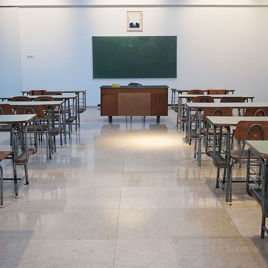 an empty classroom with chairs and desks leading to a board