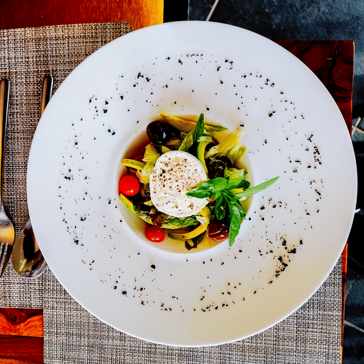 A view from above of a modern dish kept on a table - Karma Lakelands.