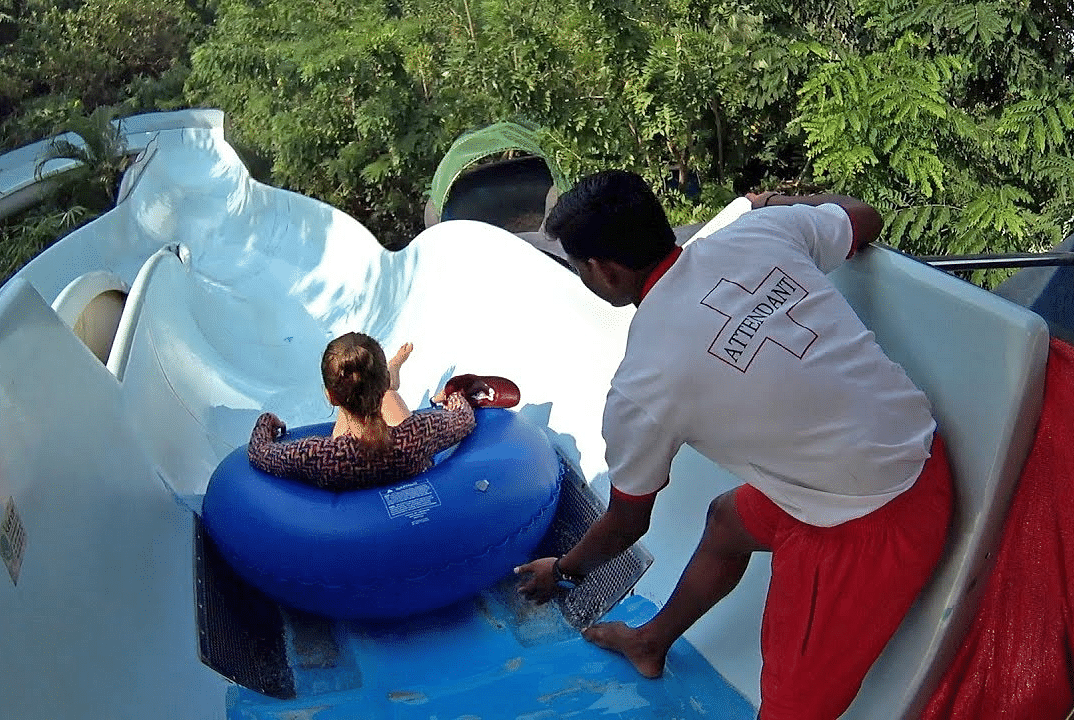A guide pushing the person sitting in the swimming tube at Rafia Fafia
