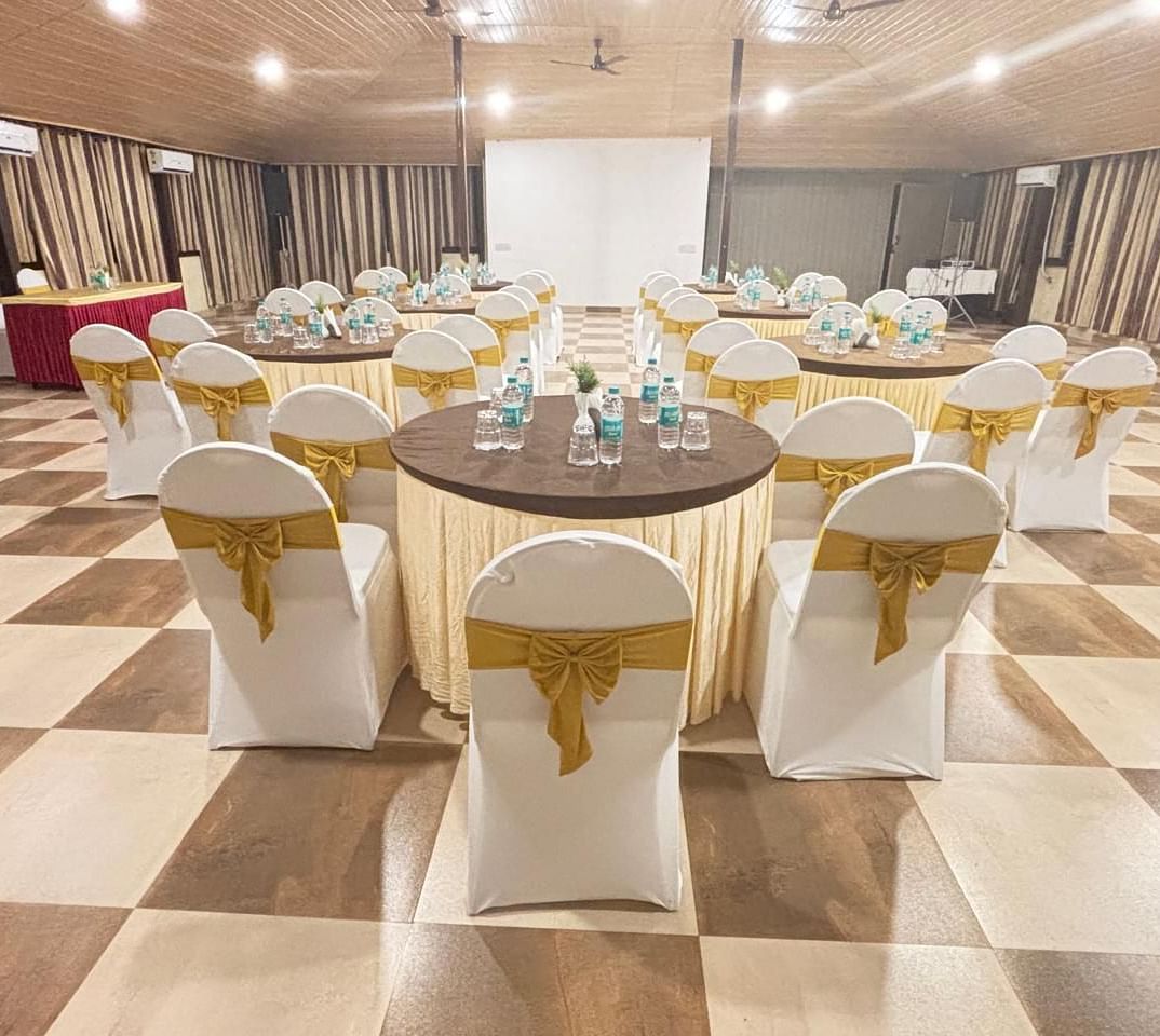 Another angle of the banquet hall, focusing on the seating arrangement and overall space | Ballroom | Woodstock Resorts, Coorg