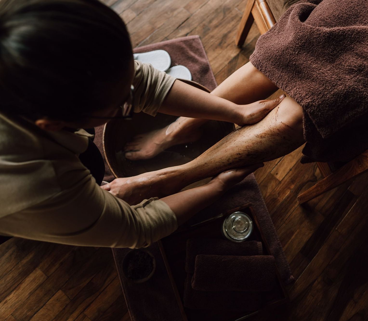 A person receiving a foot massage in a spa setting.