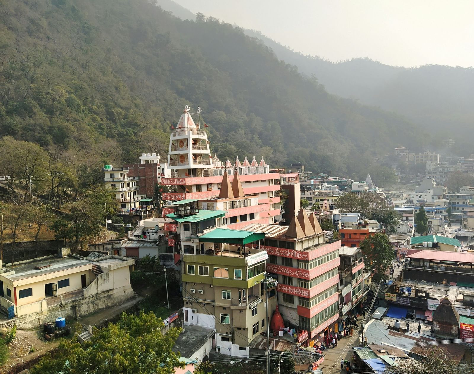 A group of buildings situated in front of a majestic mountain backdrop.