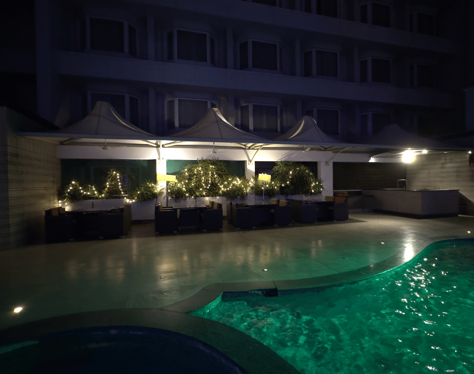 A swimming pool with the poolside dining area in the background at Cenneys Gateway.