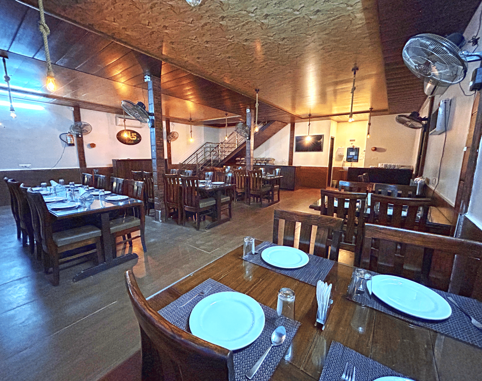 Dining area of the in-house restaurant at DLS MJ River Resort, Rishikesh.