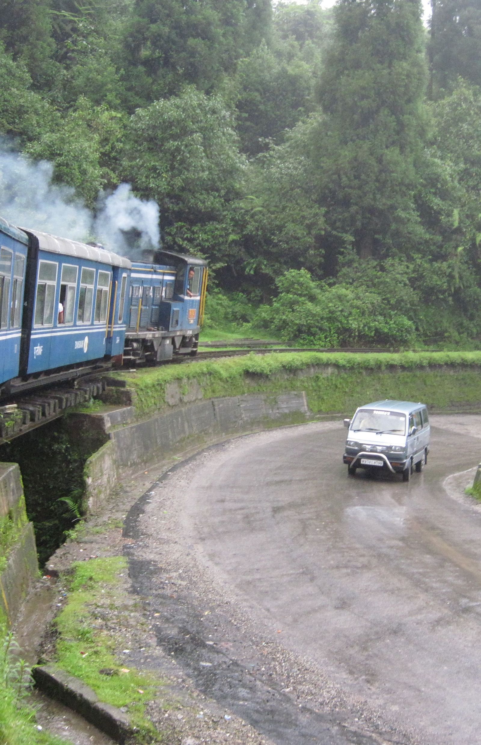 a passenger looking out from the window of a toy train in Darjeeling
