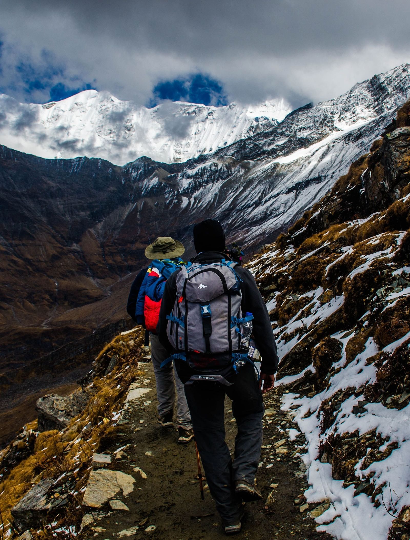 image of a group of people doing a trek on a mountain walking in a row