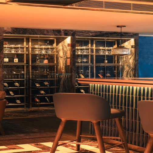 Stylish bar interior with warm lighting and seating at The Residency Towers Chennai.