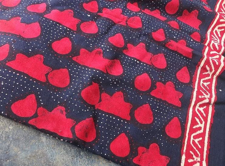A piece of patterned fabric with a decorative border is shown.