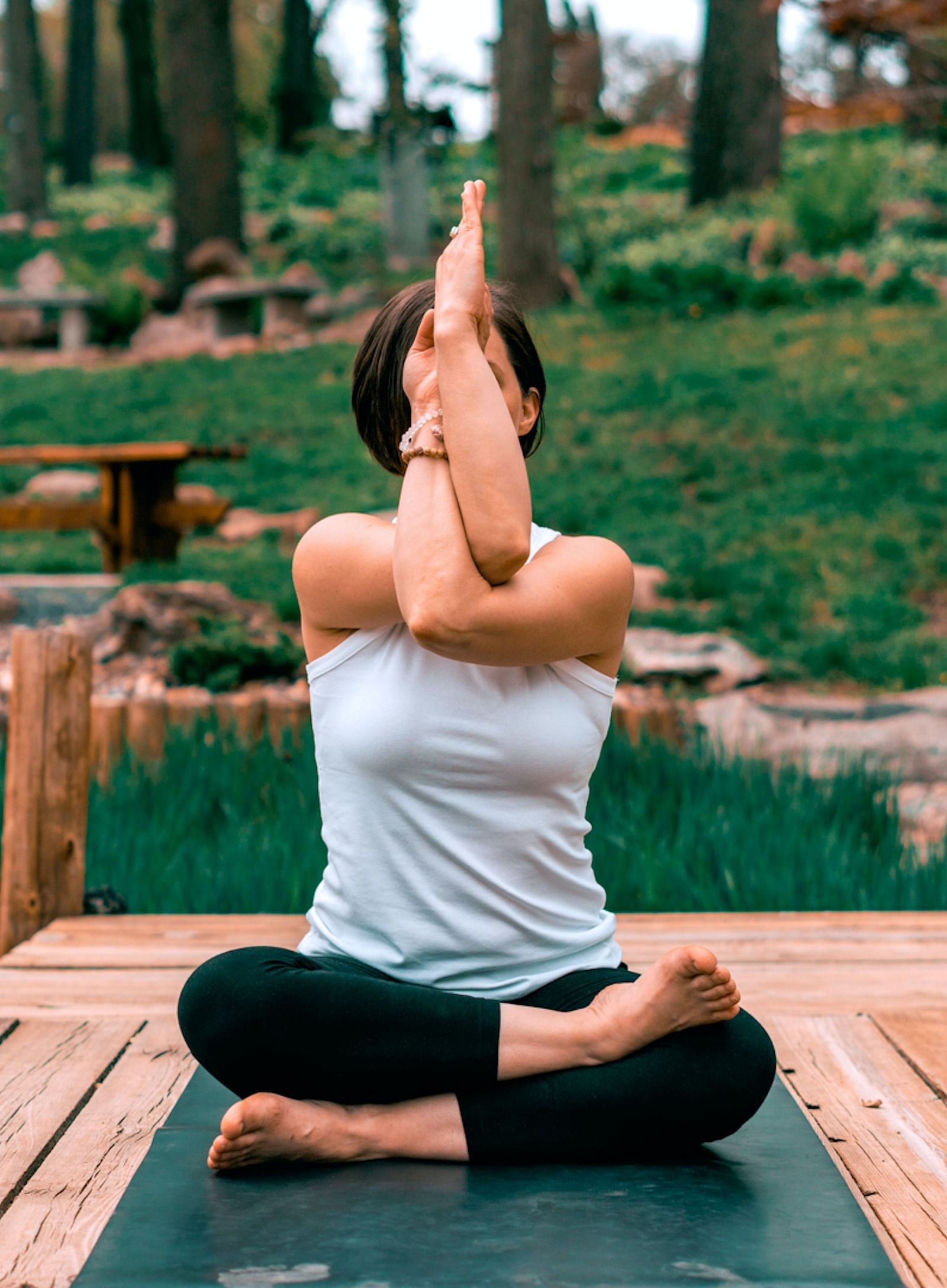 a woman in a yoga pose during daytime