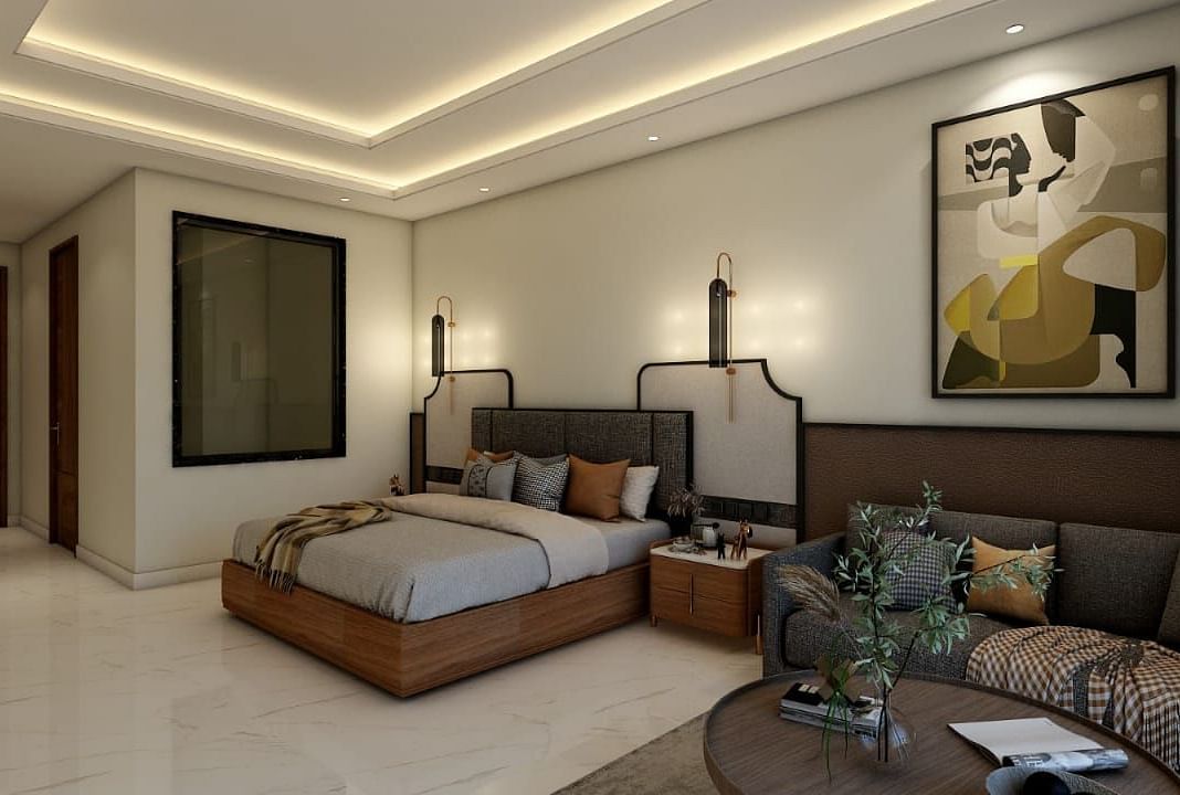 A bedroom with slightly low lighting featuring a double bed with an artistic head board along with a common seating area besides it. - Namaste Corbett