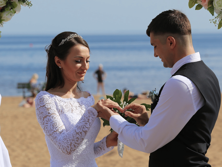 Groom placing wedding ring on the bride at a beach wedding in Andaman