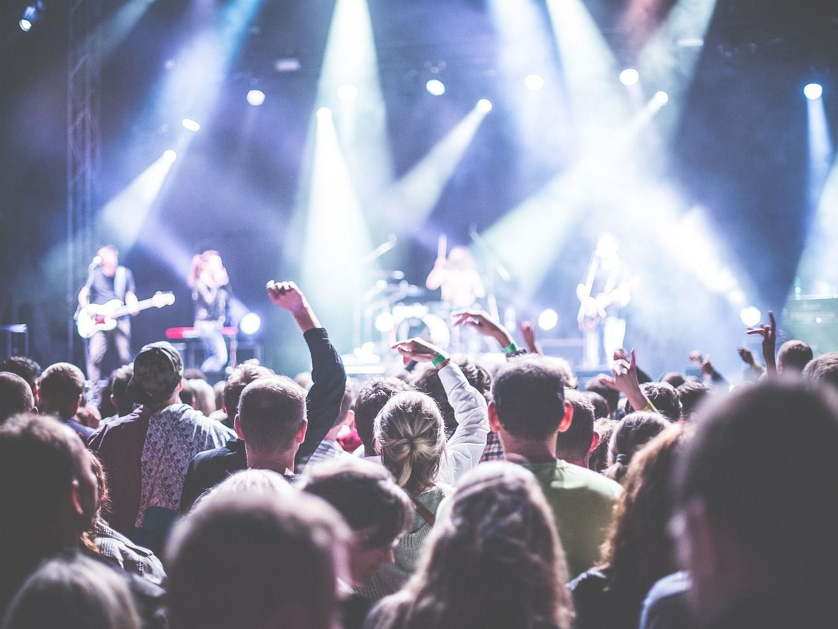 Audience dancing to a band performing on stage