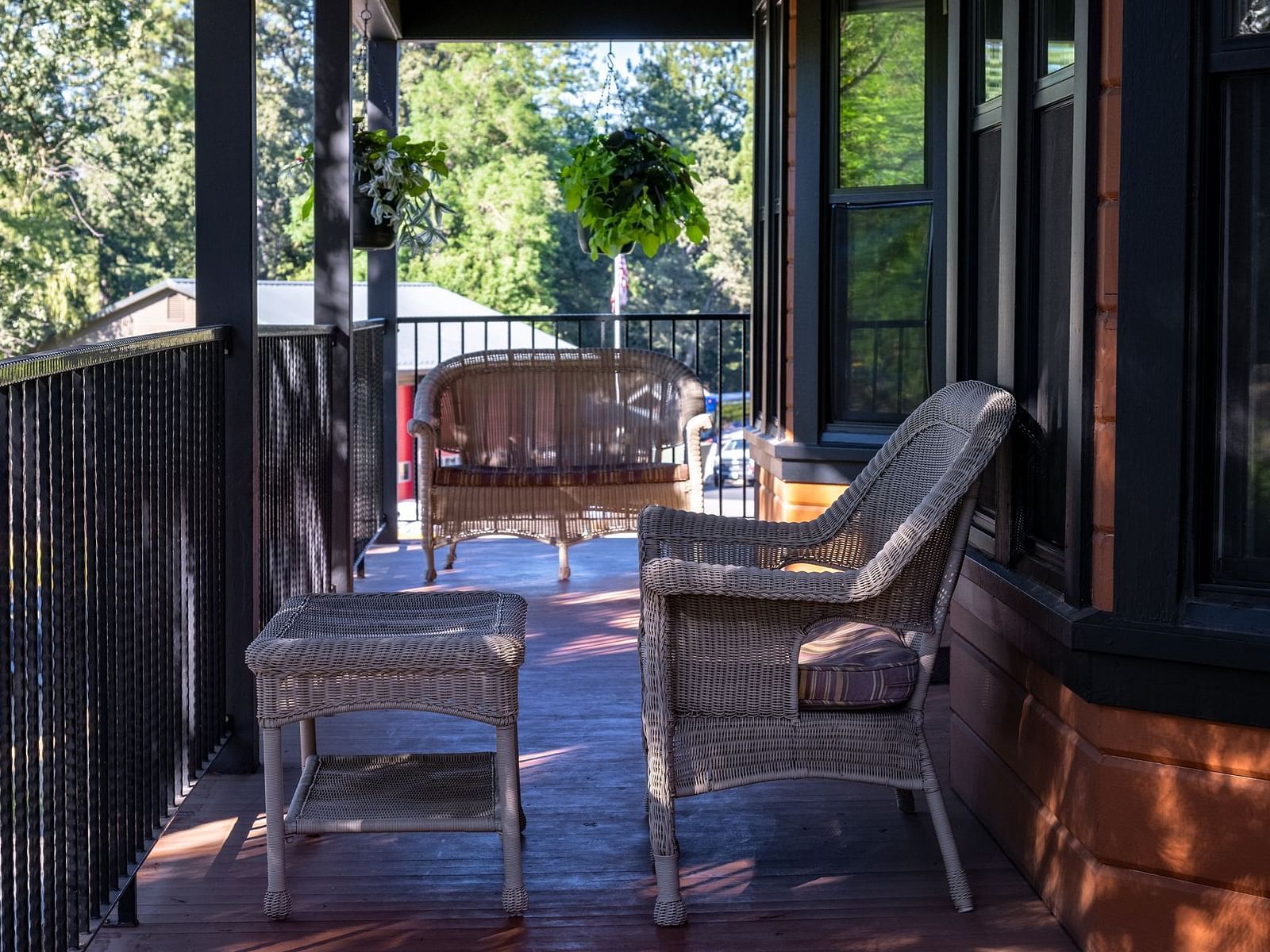 Private balcony with lounge chairs overlooking scenic greenery at The Groveland Hotel.