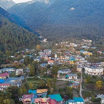a village situated in the middle of lush green mountains