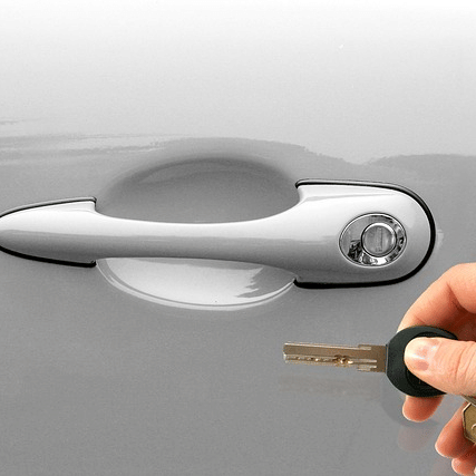 hand of a person trying to unlock the car with keys