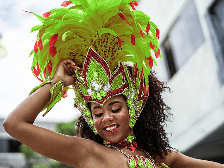 A Jamaican woman swaying gracefully in her flowing green dress - S Hotel Kingston, Jamaica
