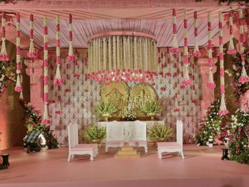 Elegant wedding stage adorned with pink floral arrangements at Central Heritage Resort and Spa.