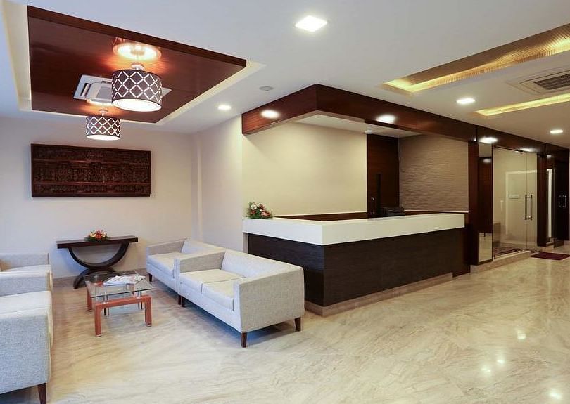 Siting area with two sets of spacious sofa and a coffee table at Fressotel Seetharam, Coimbatore