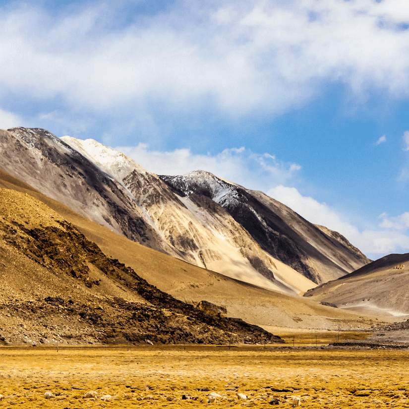 A picturesque valley with a sky partially covered with clouds in the background.