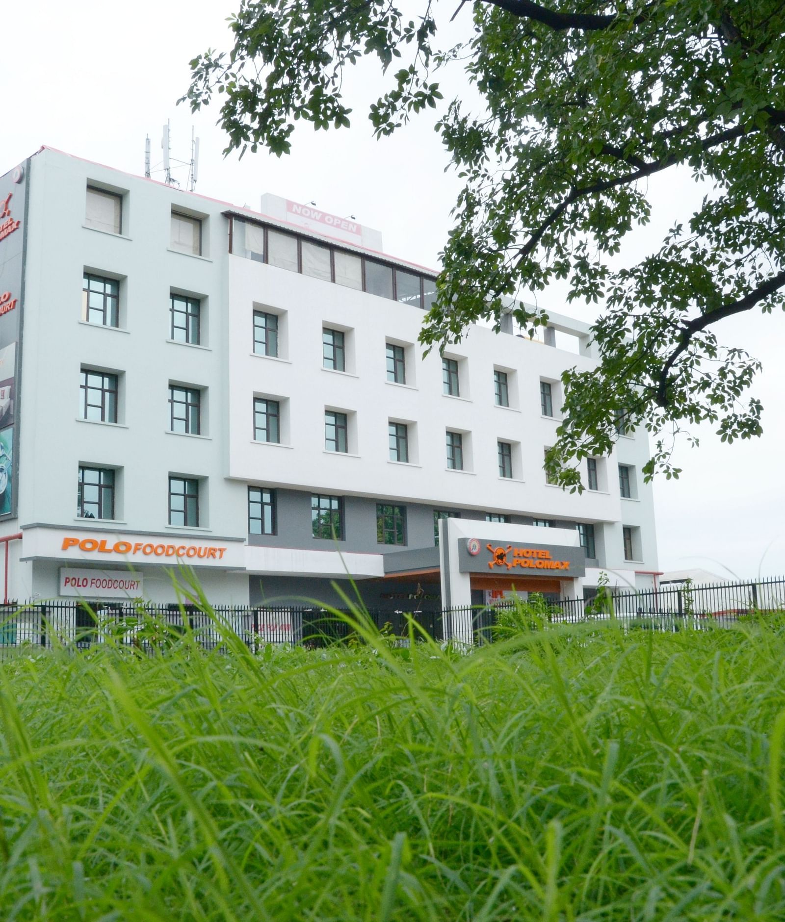 Facade view of Max Hotel Prayagraj surrounded by greenery.