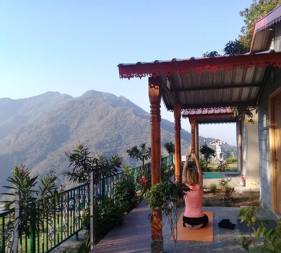 balcony seats under a conopy with mountain views - neer ganga resorts