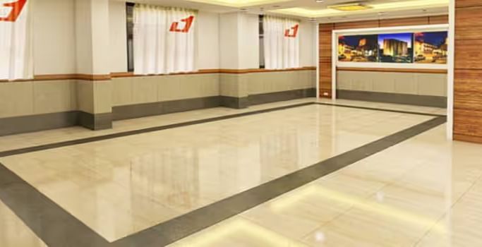 View of banquet hall called The Durbar with polished flooring and ample space for events - Max Hotel Prayagraj.