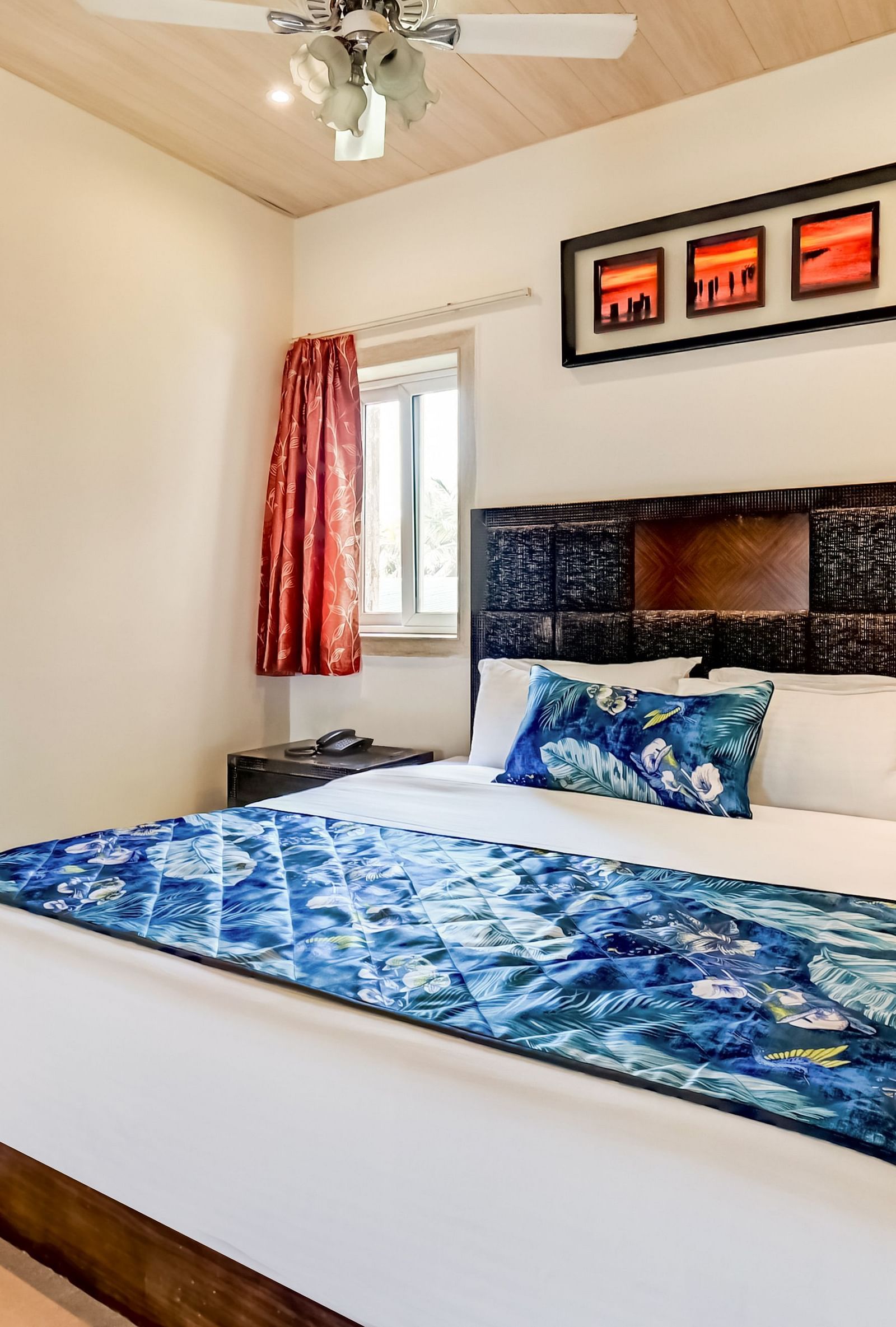  Generously sized bed accompanied by two wooden bedside tables and a large wooden wardrobe