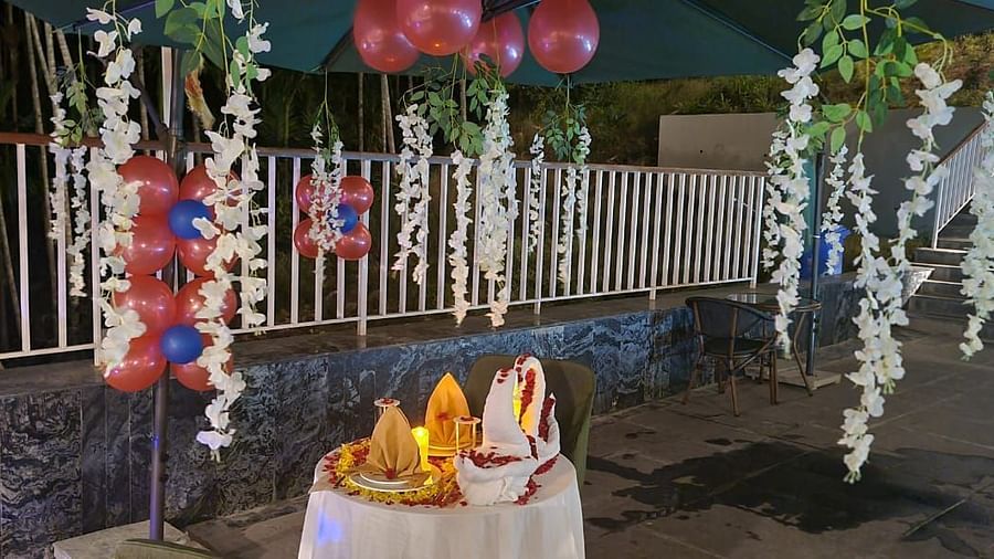 An outdoor romantic dining setting featuring hanging decorations and candles, creating a festive atmosphere. - Sea Hills Resort, Swaraj Dweep (Havelock)